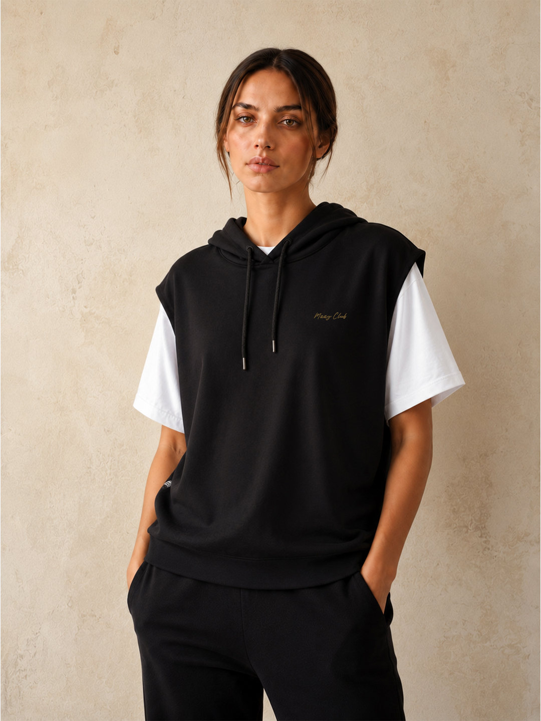 Model wearing a black hooded vest